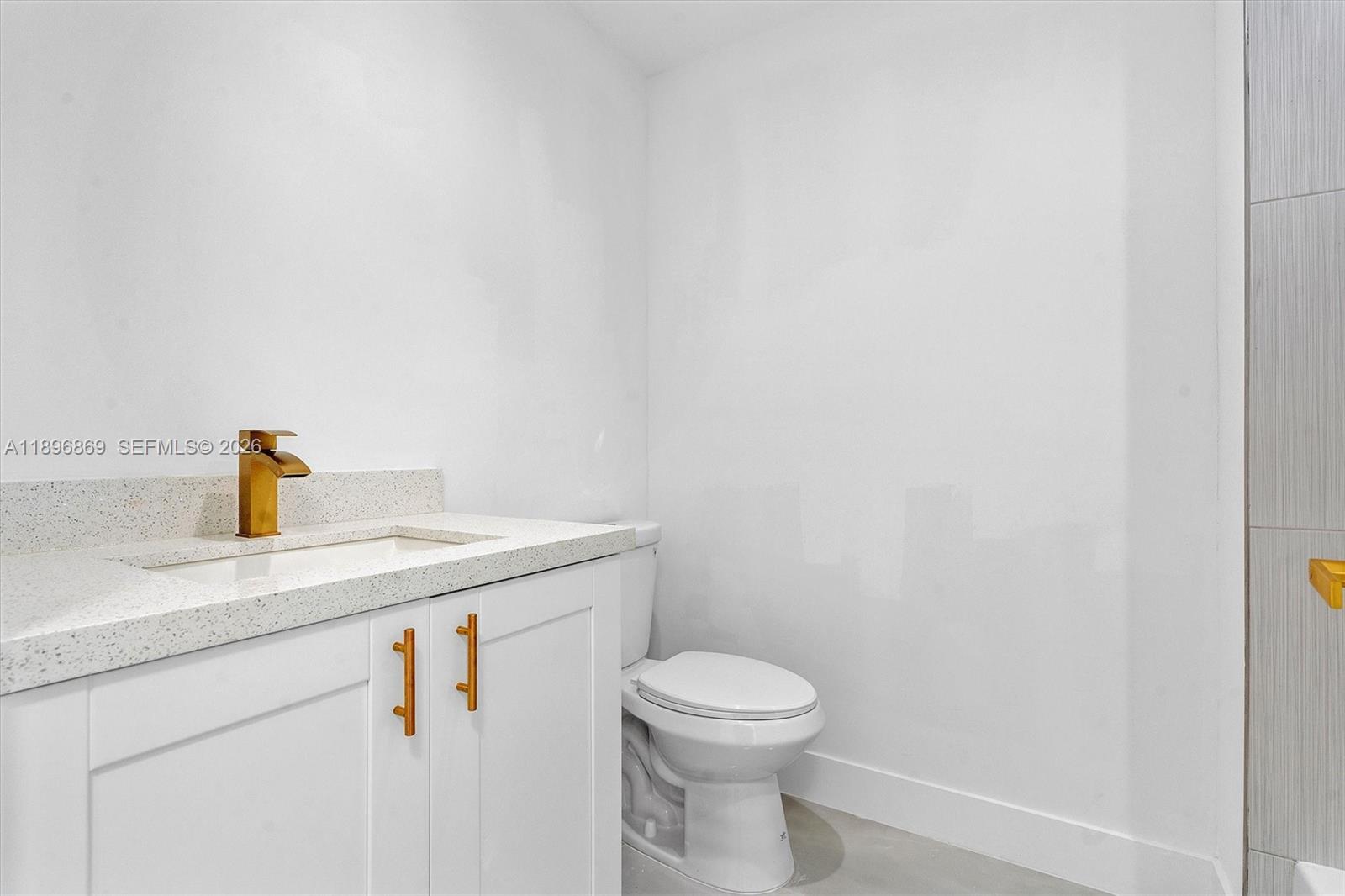 2926 Northwest 58th Street, Unit 2926 Miami, FL 33142 - Photo 13 of 28 a close up of a sink and a toilet