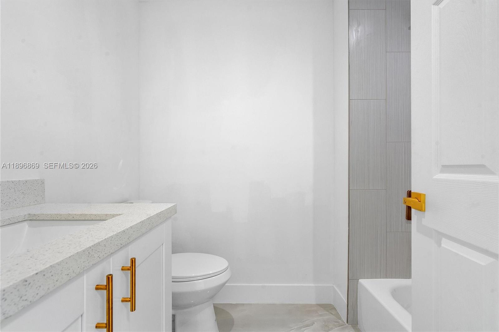 2926 Northwest 58th Street, Unit 2926 Miami, FL 33142 - Photo 14 of 28 a white toilet sitting next to a bathroom sink