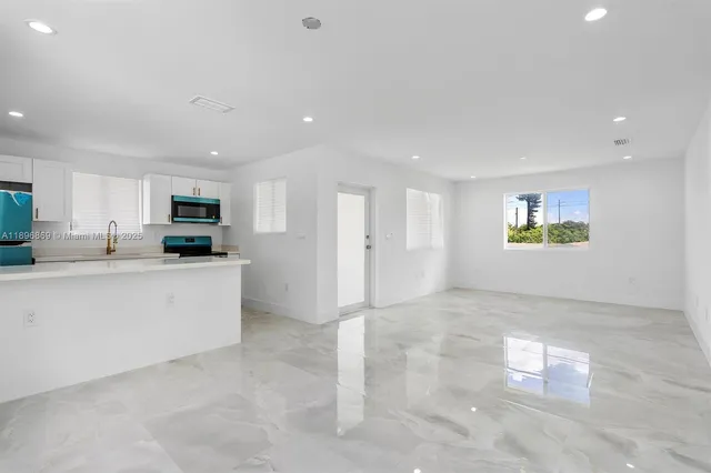 a view of a kitchen with electric appliances