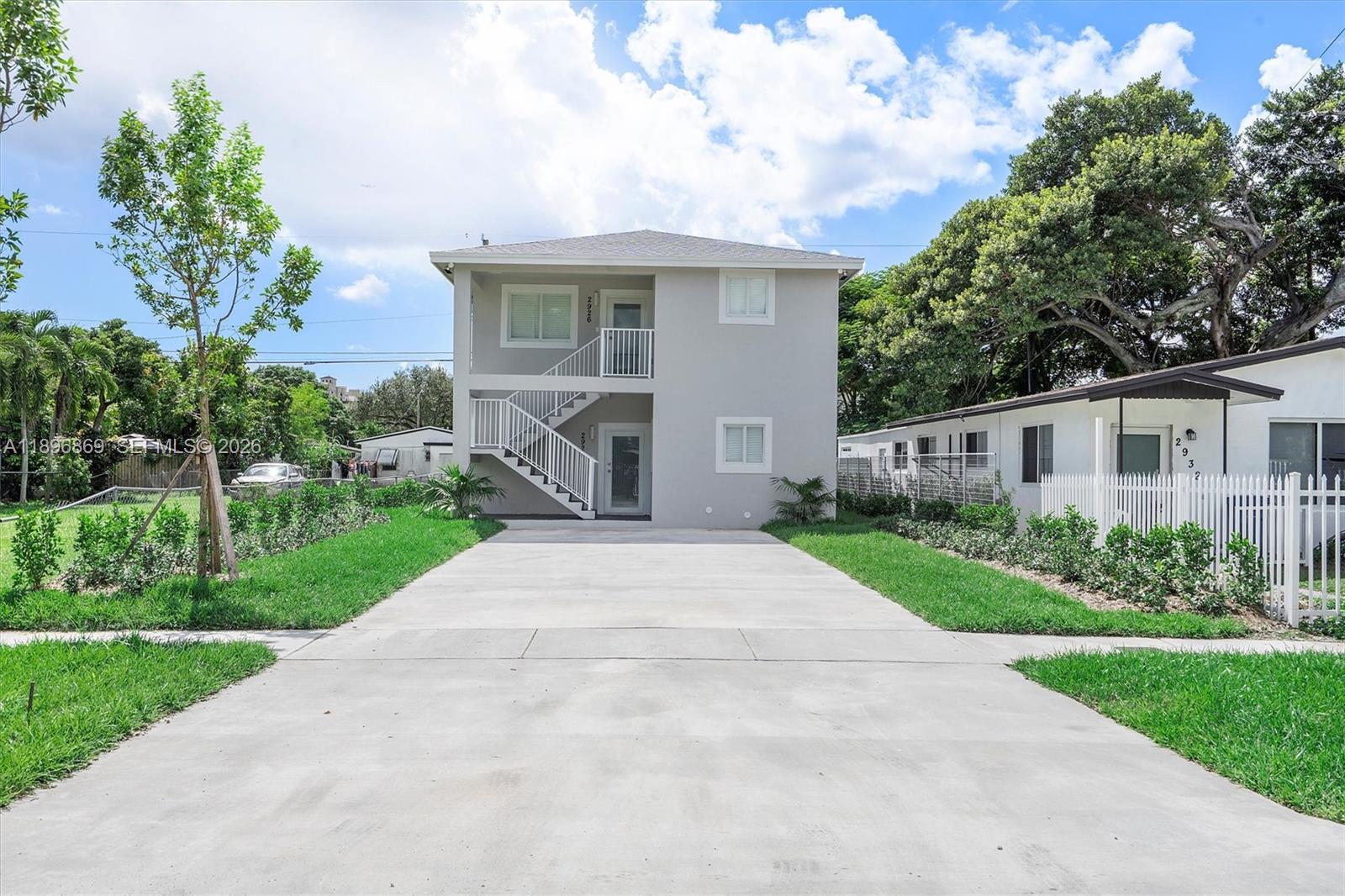 2926 Northwest 58th Street, Unit 2926 Miami, FL 33142 - Photo 25 of 28 a front view of house with yard and green space