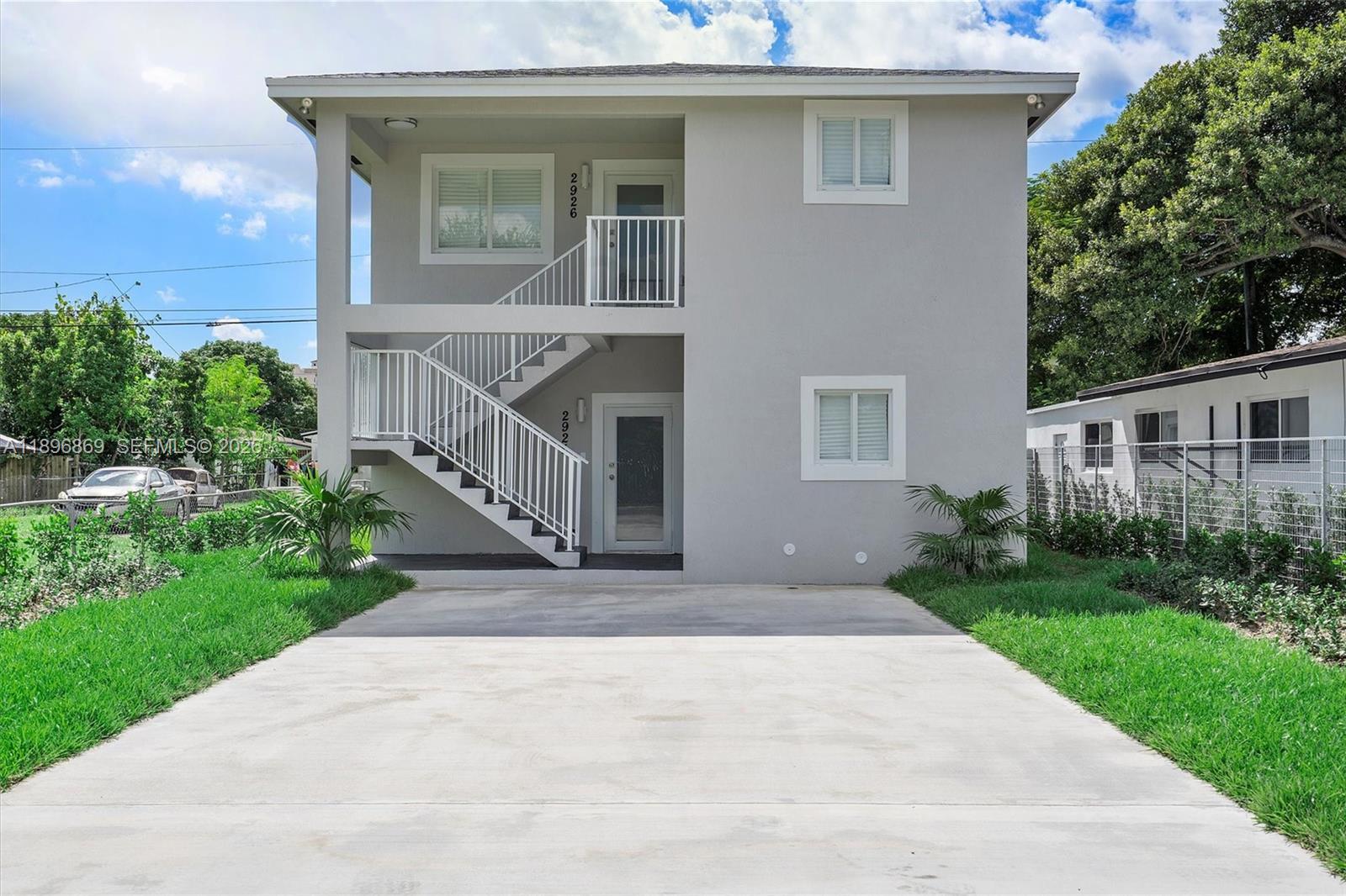 2926 Northwest 58th Street, Unit 2926 Miami, FL 33142 - Photo 26 of 28 a front view of a house with yard