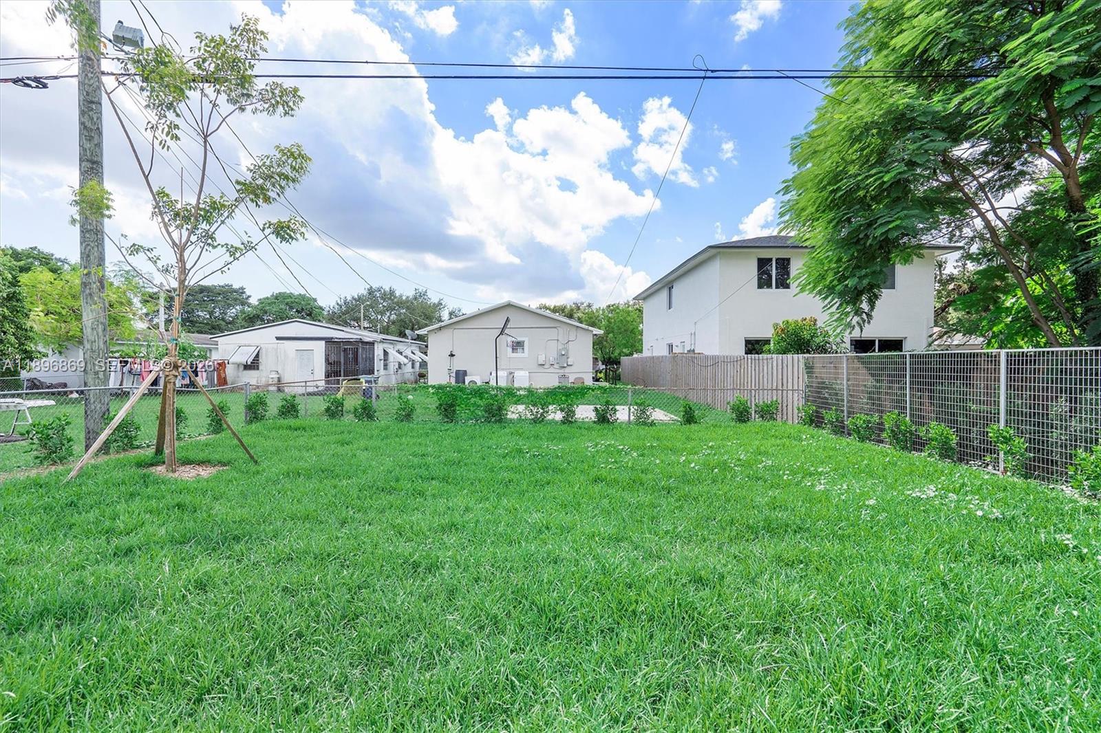 2926 Northwest 58th Street, Unit 2926 Miami, FL 33142 - Photo 28 of 28 a view of a house with backyard and a sitting area