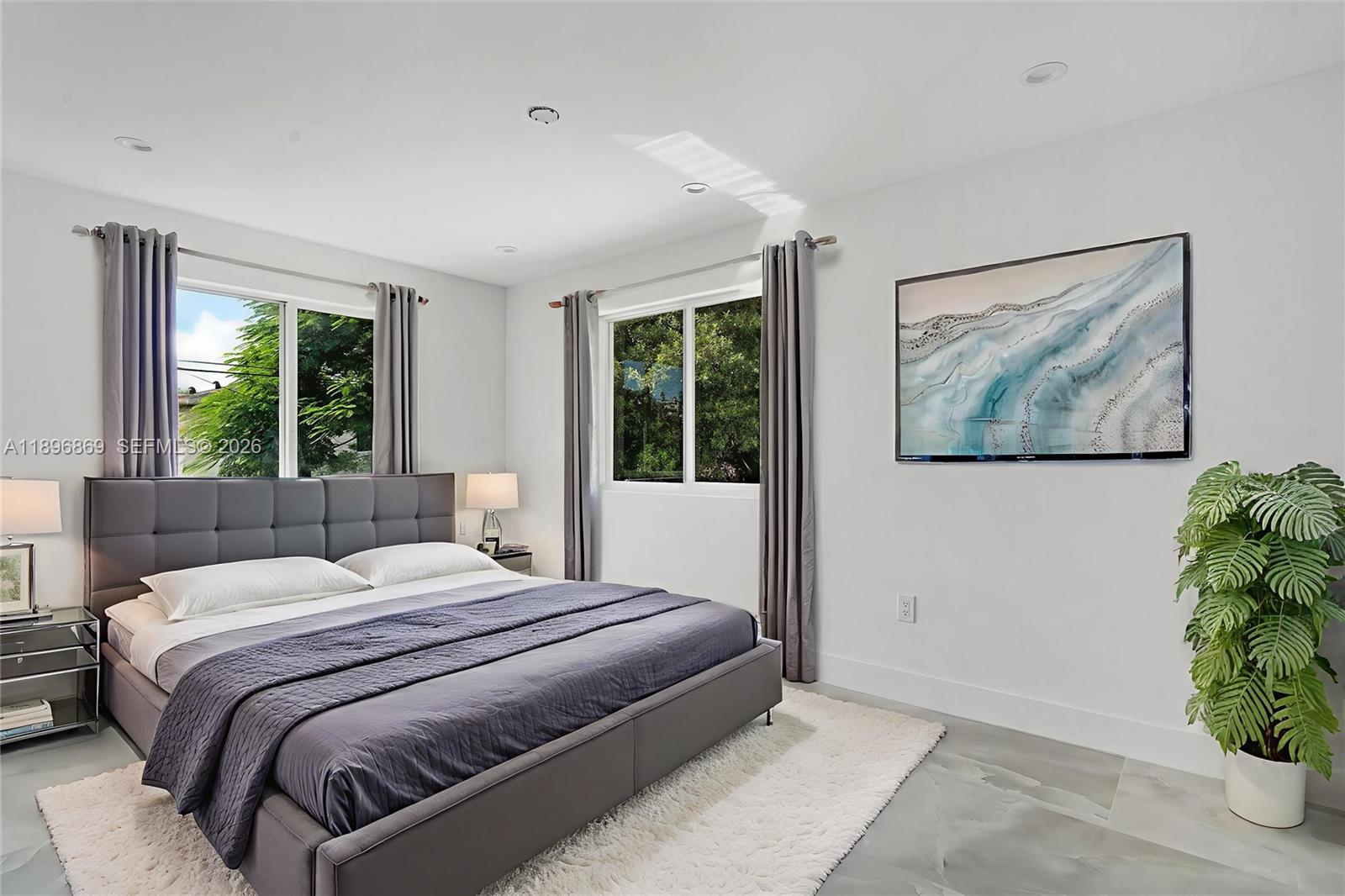 2926 Northwest 58th Street, Unit 2926 Miami, FL 33142 - Photo 3 of 28 a bedroom with a large bed and a window