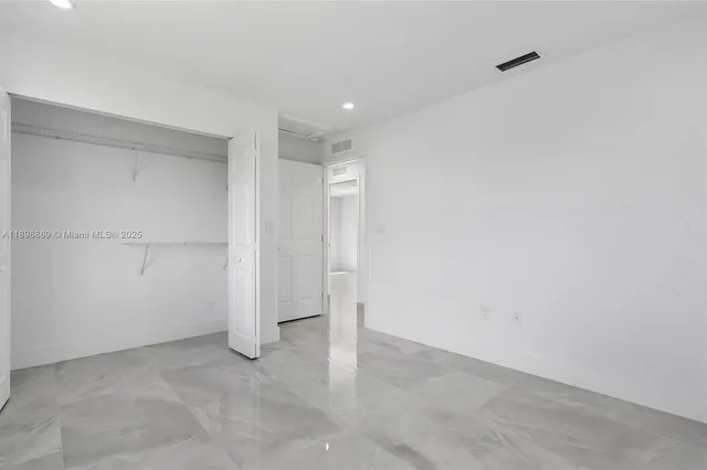 a view of a hallway with wooden shelves