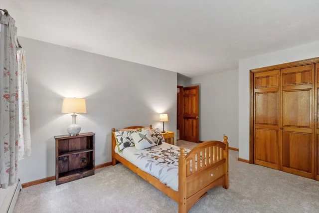 a bedroom with a bed and a lamp