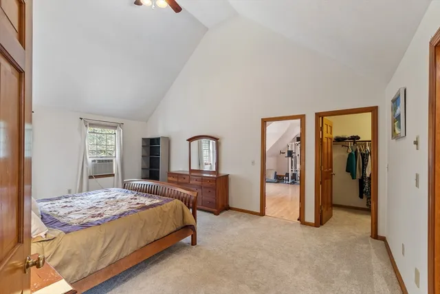 a bedroom with a large bed and a dresser