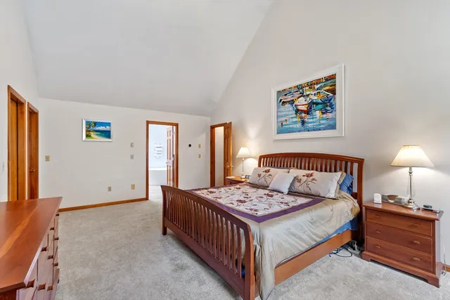 a bedroom with a bed and a lamp on table
