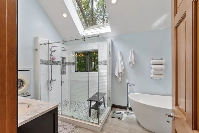 a bathroom with a tub shower and sink