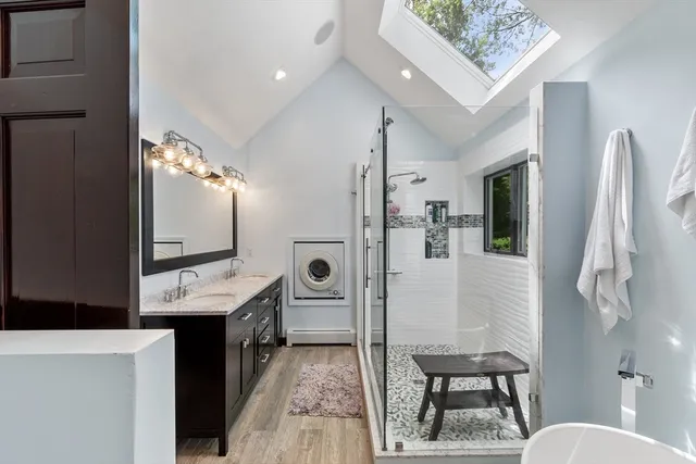 a bathroom with a sink a toilet and a mirror