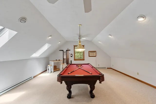 a room with pool table windows and a chandelier