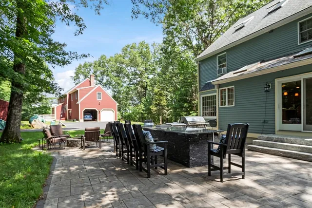 a view of backyard with outdoor seating a patio and plants