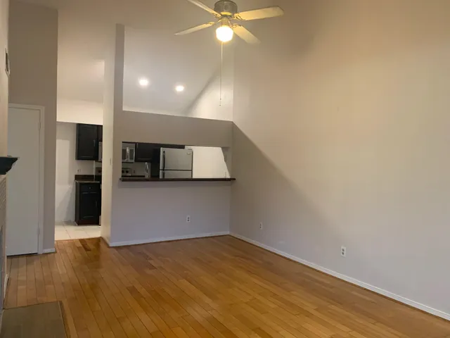 a view of a kitchen with a sink and a refrigerator