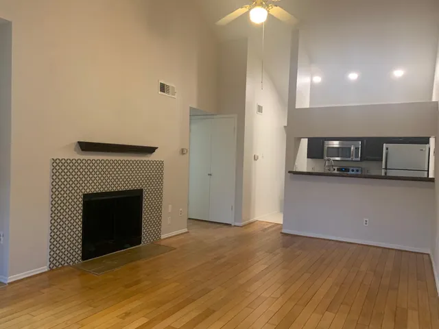 a view of a livingroom with an empty space and a fireplace