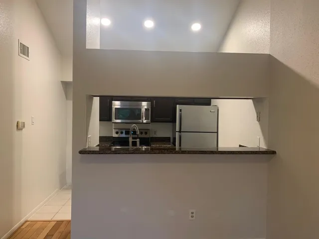 a kitchen with a sink and a mirror