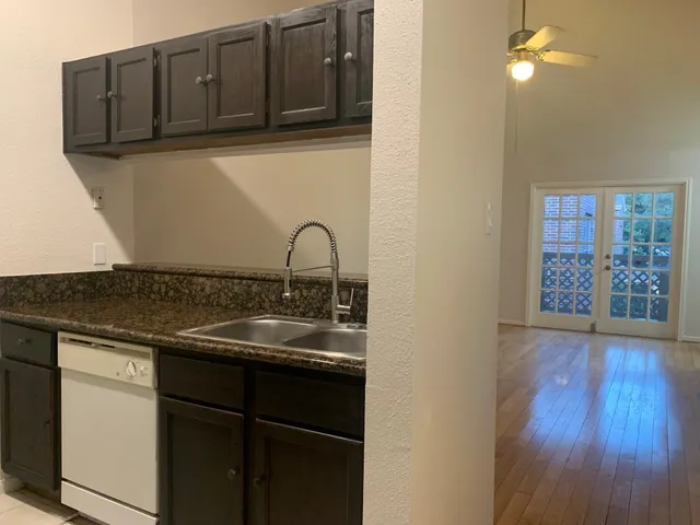 a kitchen with a sink and cabinets
