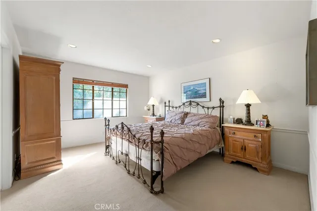a view of a dining room with furniture a chandelier and kitchen view