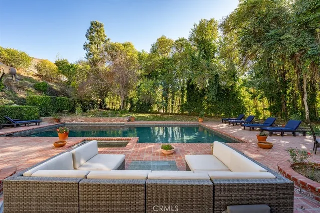 a bedroom with a bed and a computer on the desk
