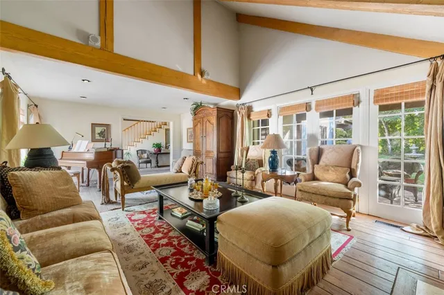 a living room with furniture fireplace and a large window