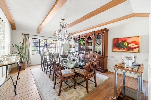 a front view of a house with a yard and potted plants