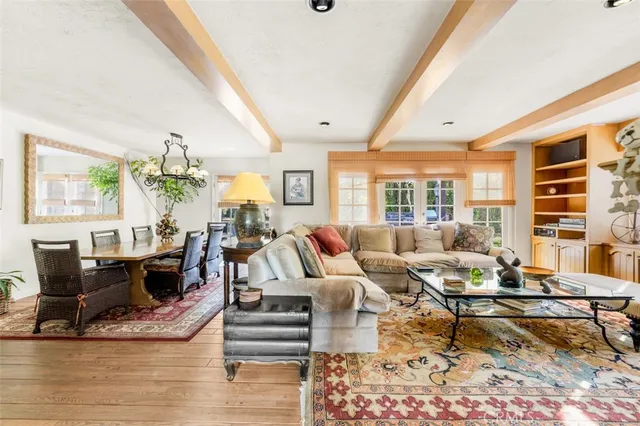 an aerial view of a house with table and chairs under an umbrella