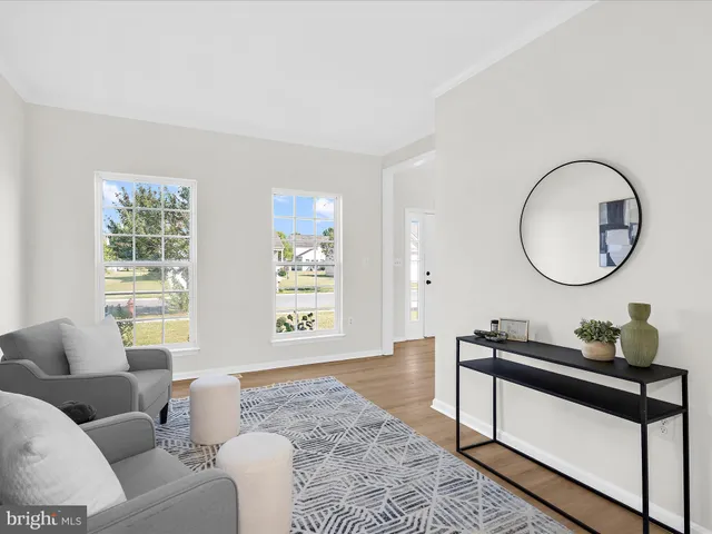 a living room with furniture and a mirror