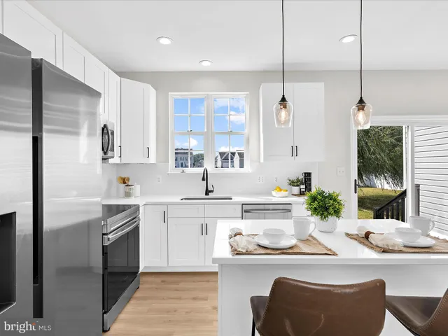 a kitchen with stainless steel appliances kitchen island granite countertop a sink and cabinets