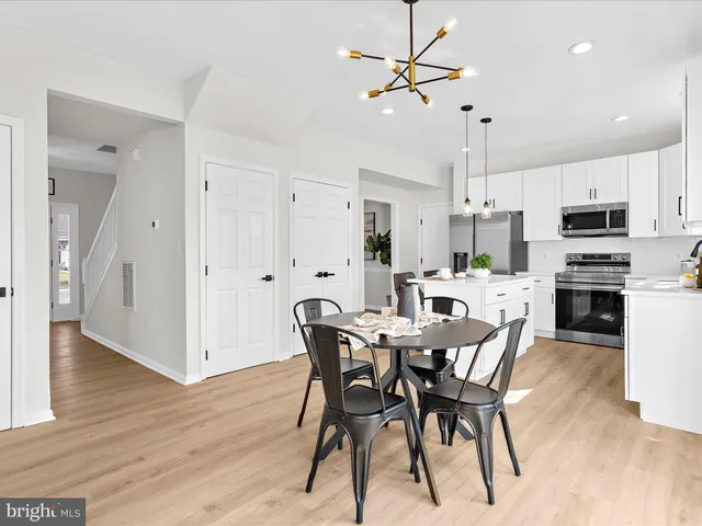a view of a dining room with furniture wooden floor and chandelier