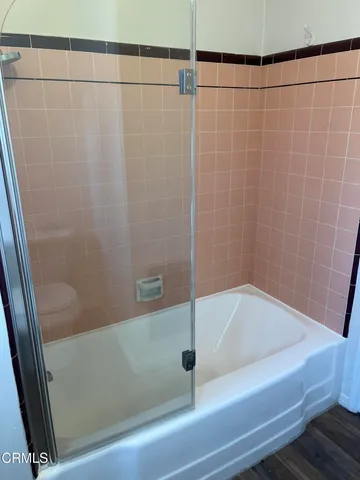 a bathroom with a shower and a bathtub