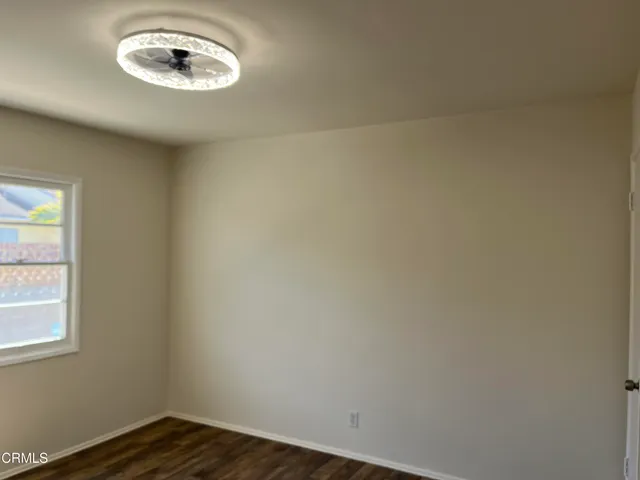 a view of a room with a wooden floor and a window