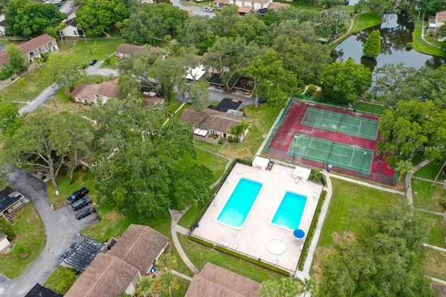 an aerial view of residential houses with outdoor space and swimming pool