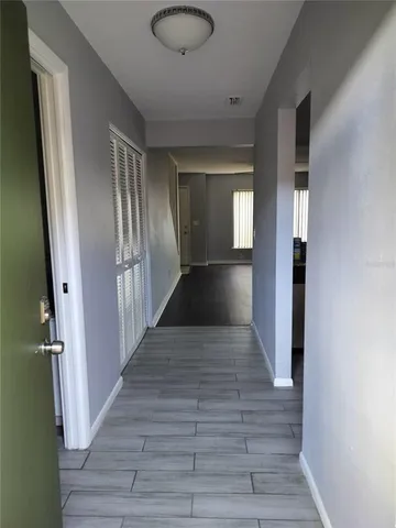 a view of a hallway with wooden floor