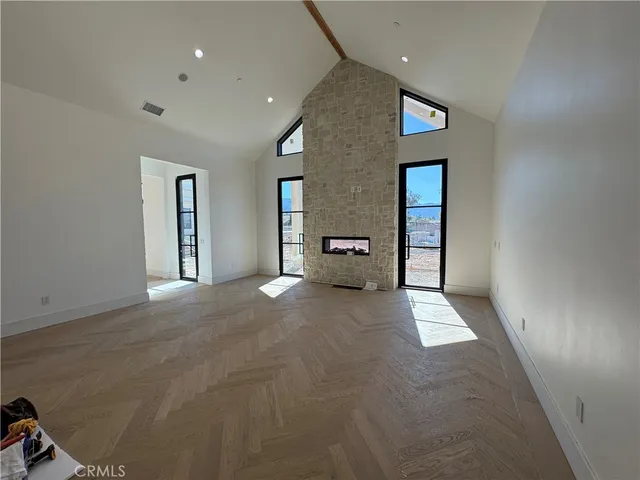 en empty room with windows and couch