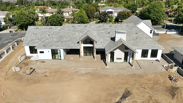 an aerial view of residential houses with yard