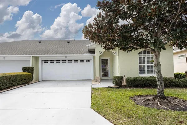 a view of a house with a yard and a garage