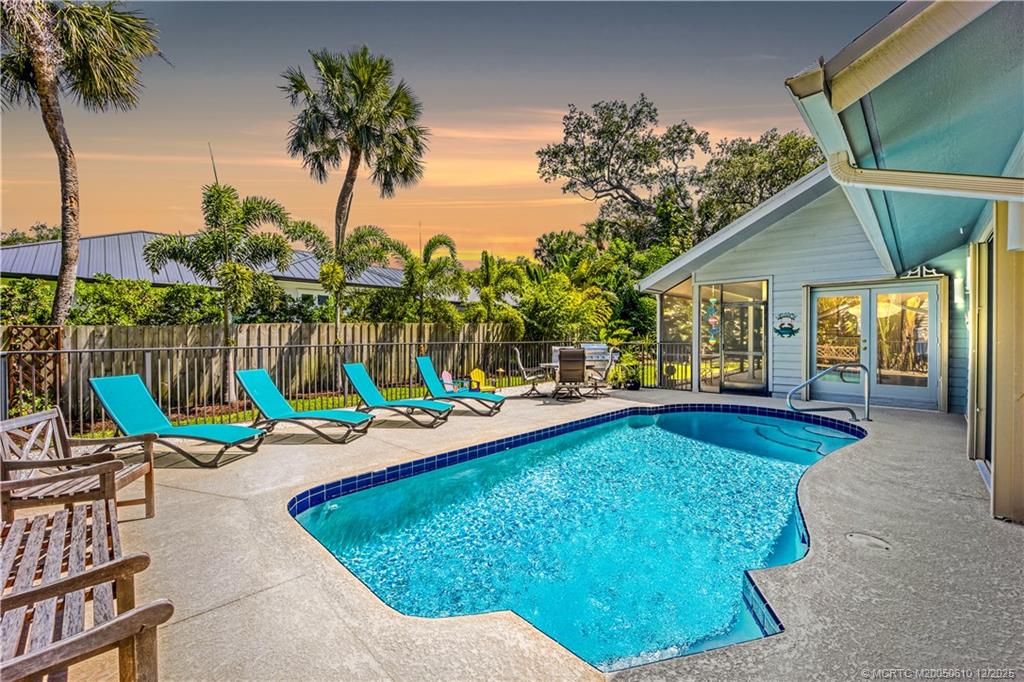 a view of an house with swimming pool and sitting area