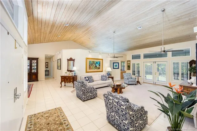 a dining room with furniture a rug and a chandelier
