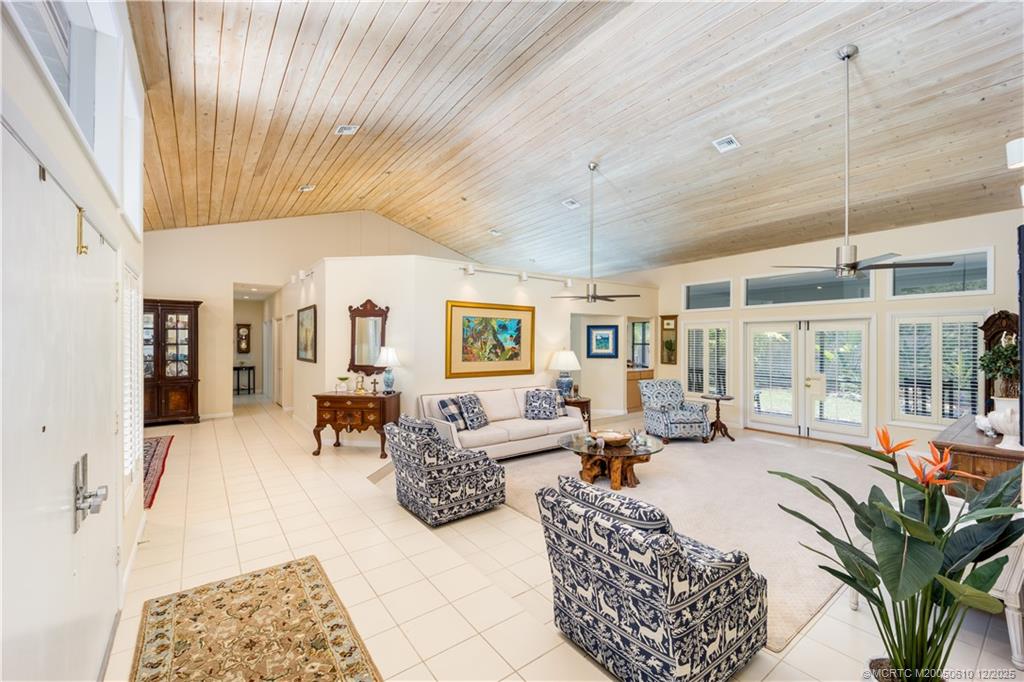 8 Kingston Court Stuart, FL 34996 - Photo 12 of 51 a living room with furniture fireplace and large windows