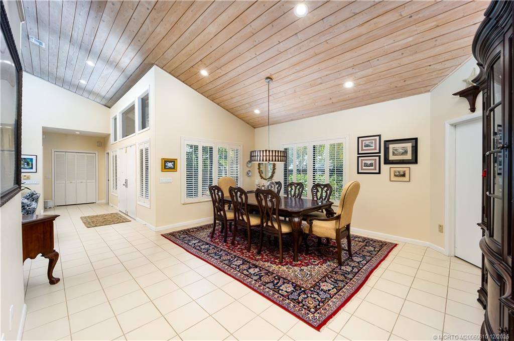 8 Kingston Court Stuart, FL 34996 - Photo 15 of 51 a dining room with furniture a rug and a chandelier