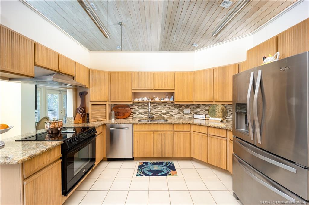 8 Kingston Court Stuart, FL 34996 - Photo 17 of 51 a kitchen with stainless steel appliances granite countertop a refrigerator and a stove top oven