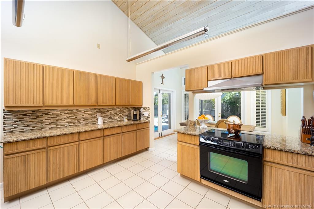8 Kingston Court Stuart, FL 34996 - Photo 19 of 51 a kitchen with stainless steel appliances granite countertop a stove and a white cabinets