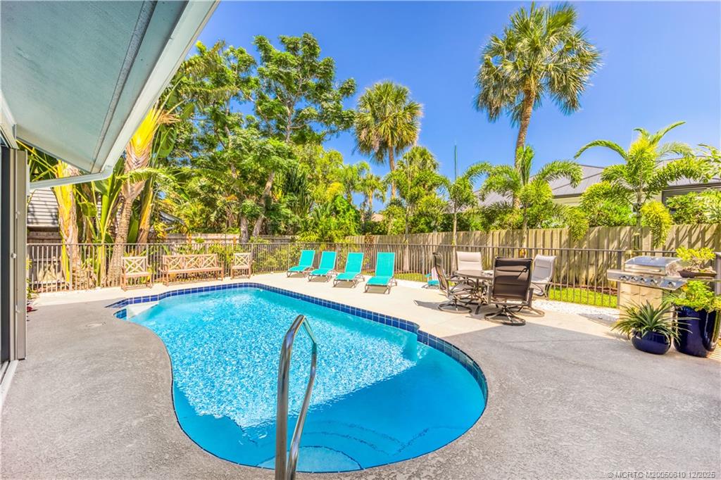 8 Kingston Court Stuart, FL 34996 - Photo 22 of 51 a view of a swimming pool with lounge chair