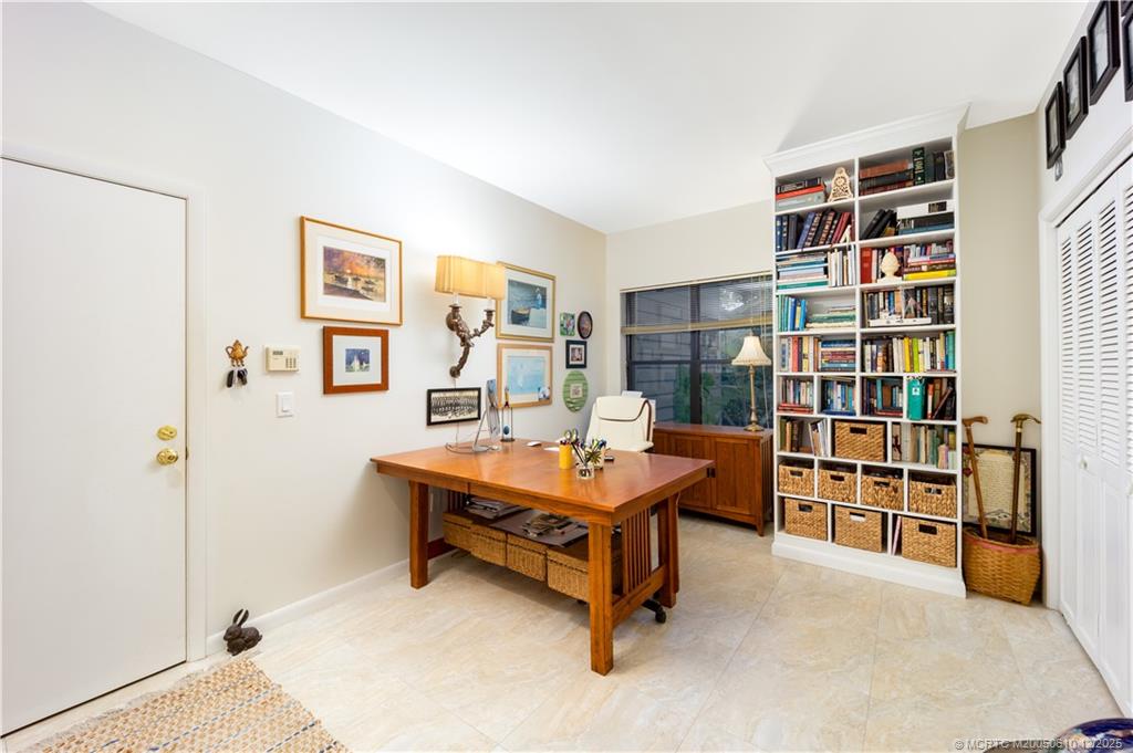 8 Kingston Court Stuart, FL 34996 - Photo 23 of 51 a room with furniture and a book shelf