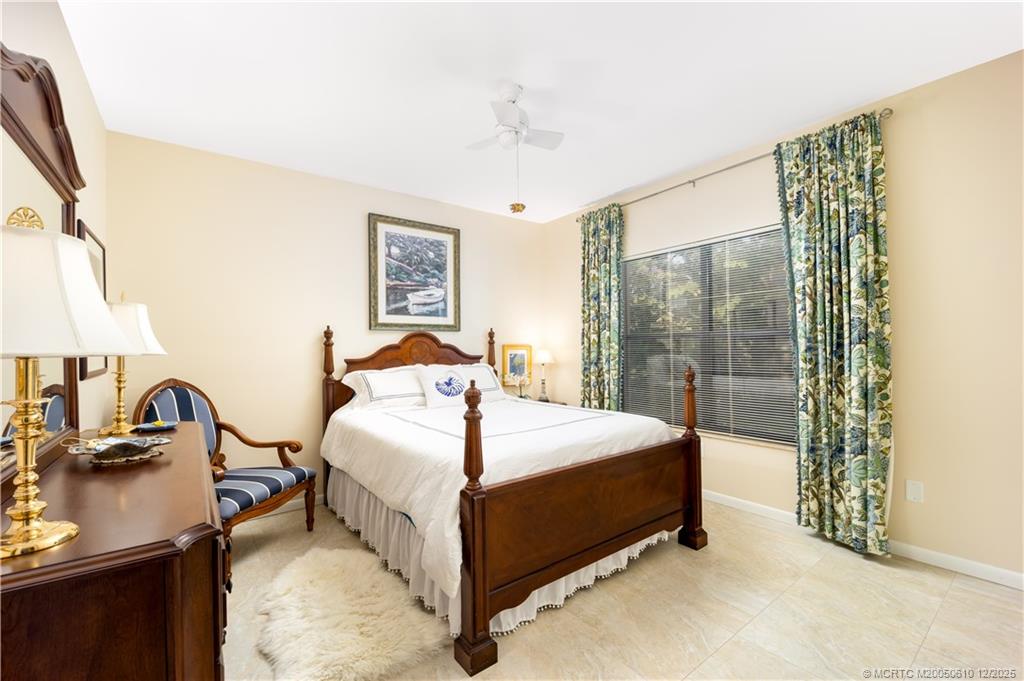 8 Kingston Court Stuart, FL 34996 - Photo 26 of 51 a bed sitting in a bedroom next to a window