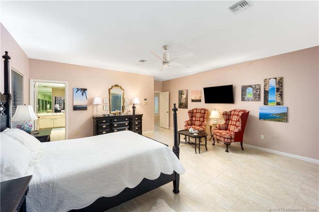 8 Kingston Court Stuart, FL 34996 - Photo 31 of 51 a large bedroom with a bed and wooden floor