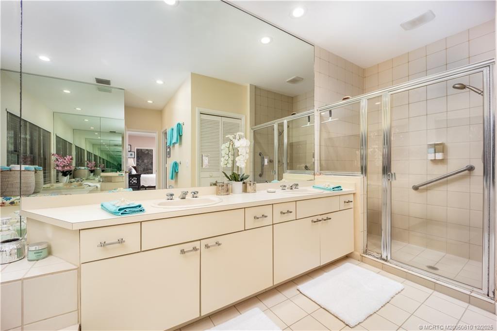 8 Kingston Court Stuart, FL 34996 - Photo 32 of 51 a bathroom with a shower sink and mirror