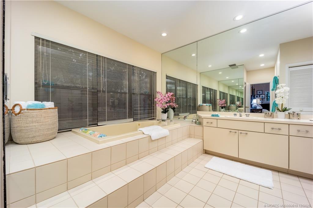 8 Kingston Court Stuart, FL 34996 - Photo 33 of 51 a bathroom with a tub sink and mirror