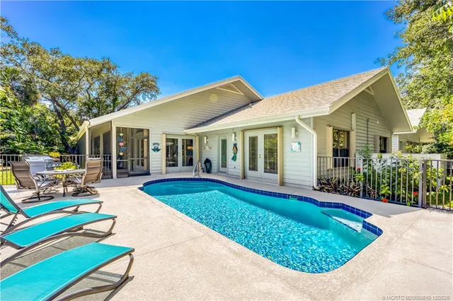 a view of a lake with lawn chairs