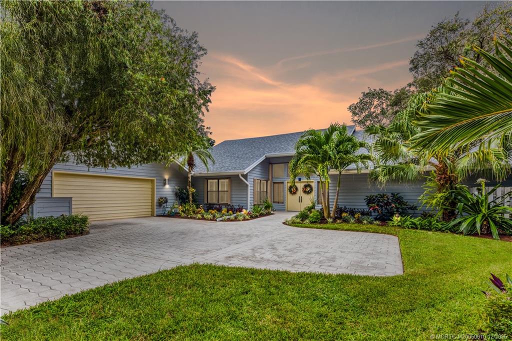 8 Kingston Court Stuart, FL 34996 - Photo 49 of 51 a front view of a house with a yard and garage