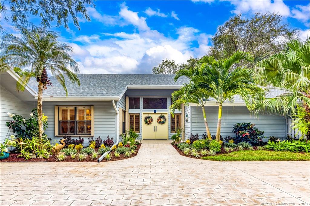 8 Kingston Court Stuart, FL 34996 - Photo 10 of 51 a front view of a house with a garden