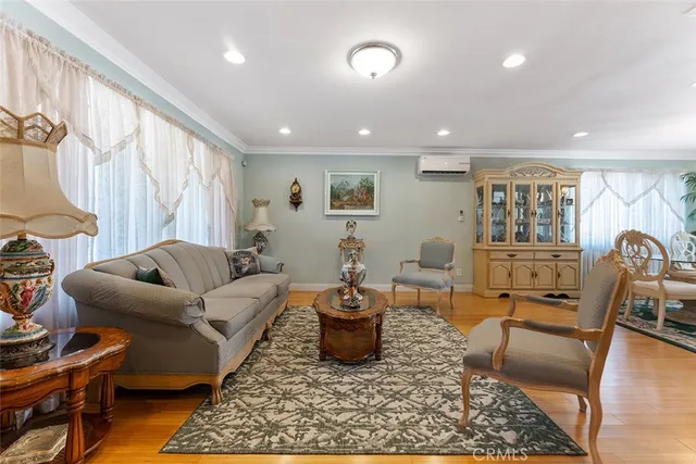 a living room with furniture a rug and a window